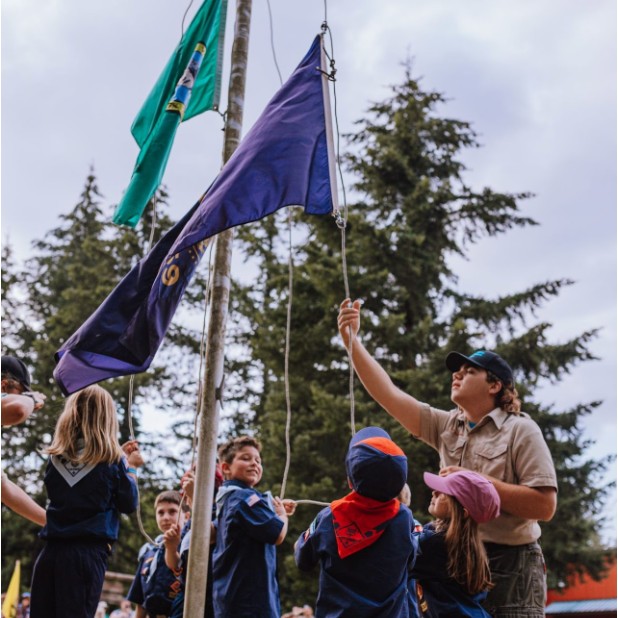 Pack 454 Scouts raising the flag at a ceremony