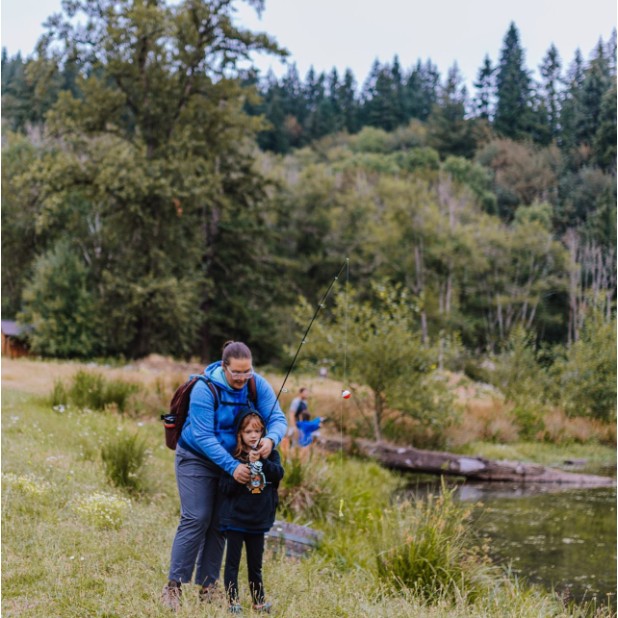 Parent and child fishing together at a Pack 454 campout