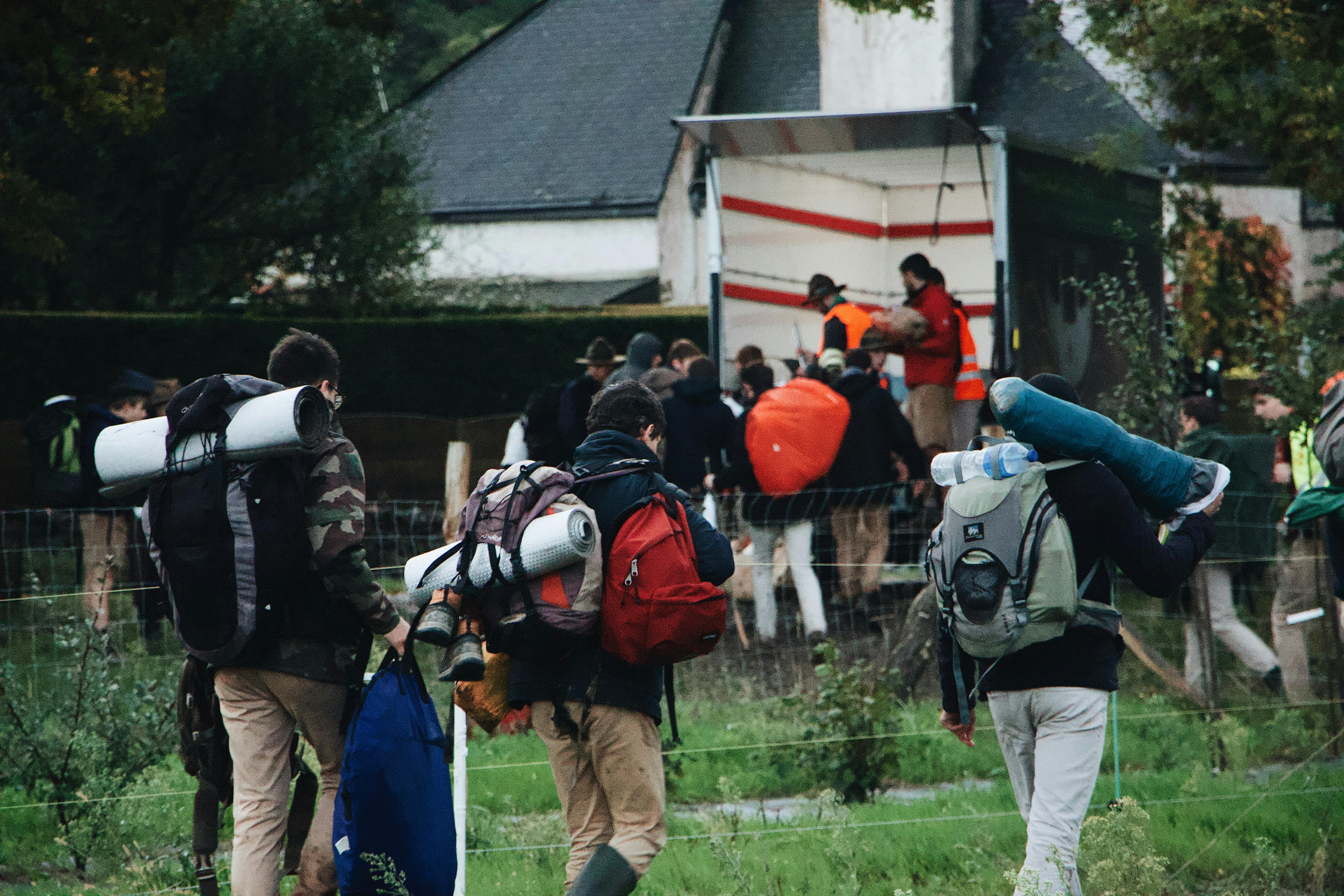 Group of hikers with backpacks walking through a forest