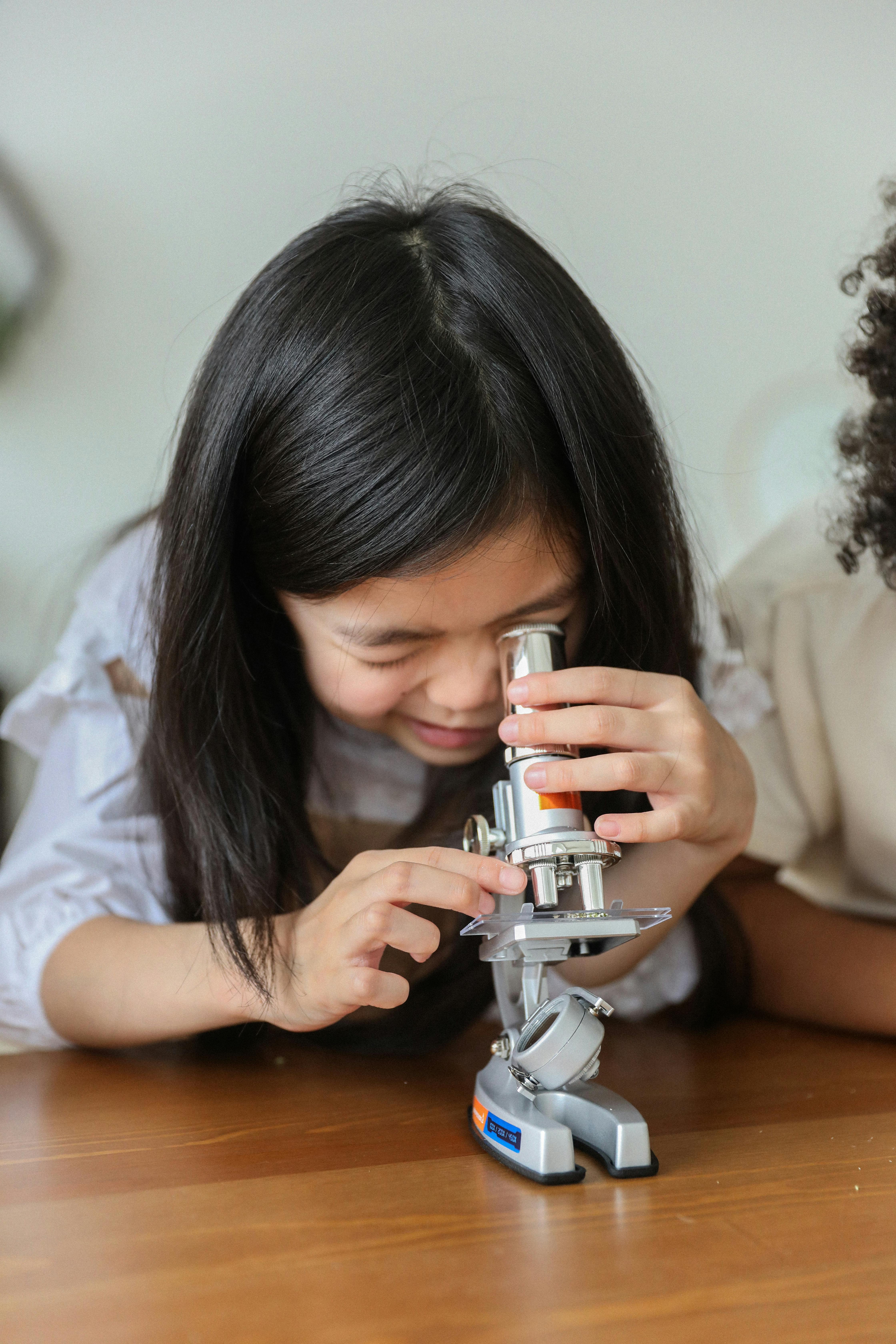Child examining science instruments, hands-on learning