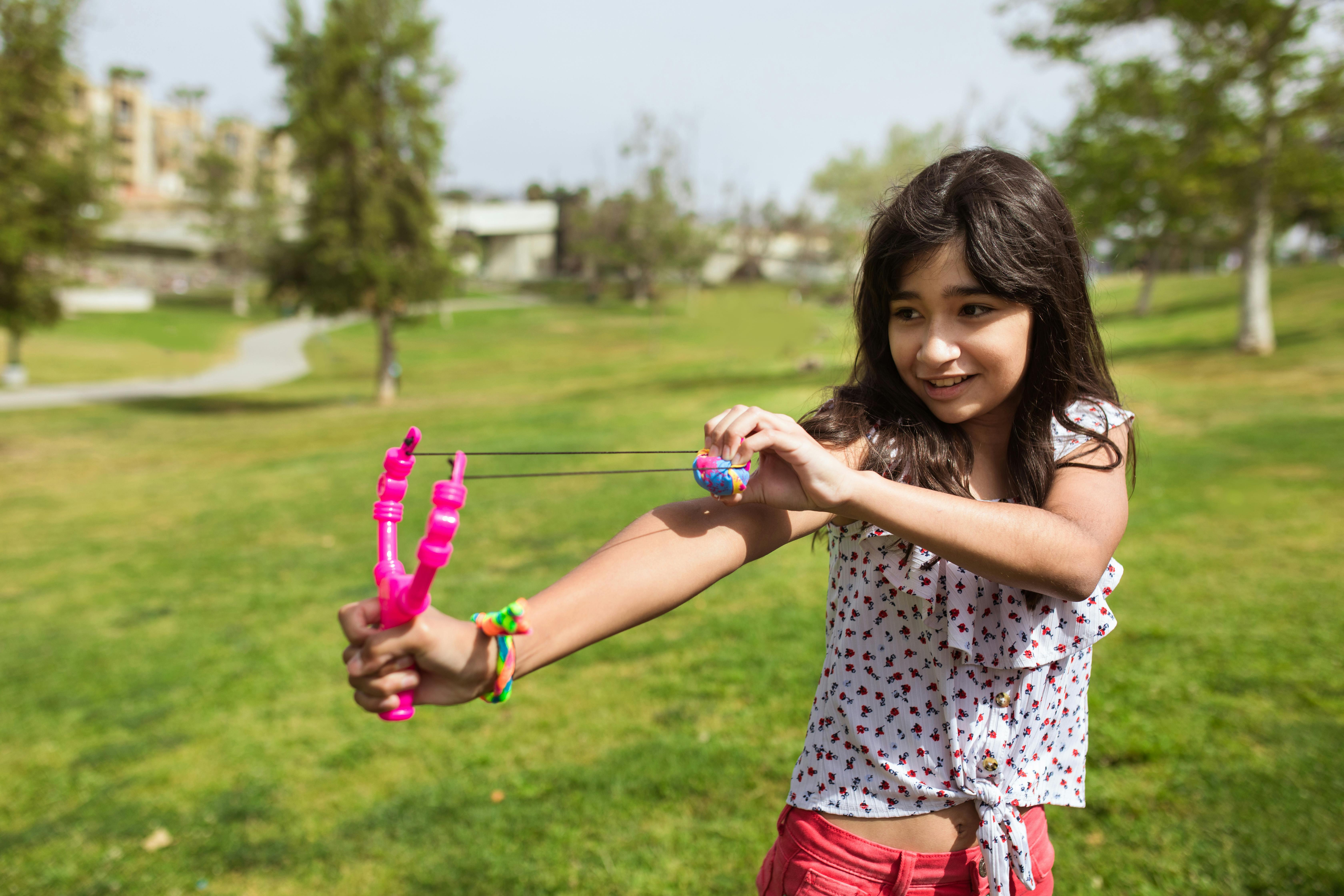 Kids at summer camp doing archery with bows