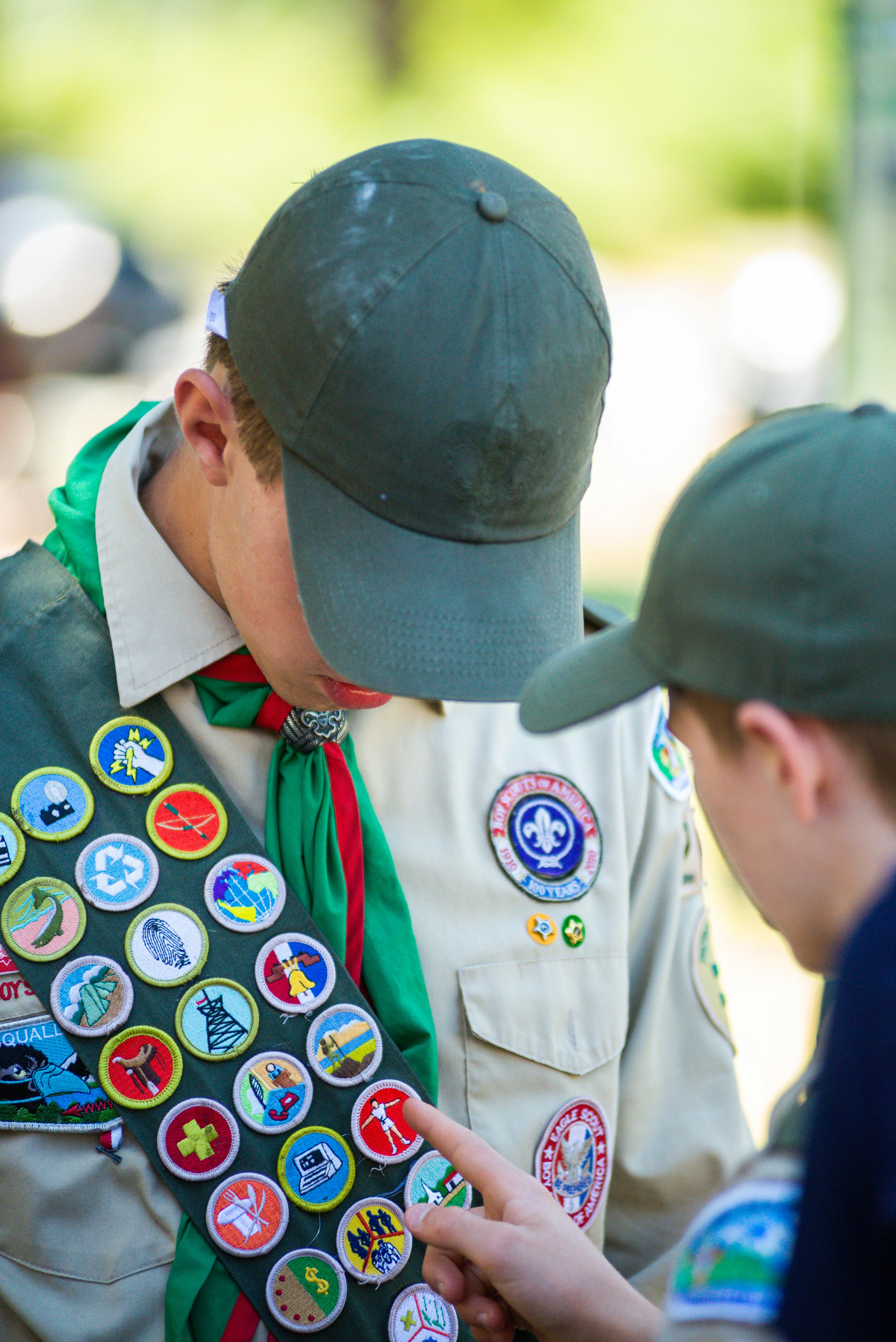 Boy Scout in uniform with merit badge sash
