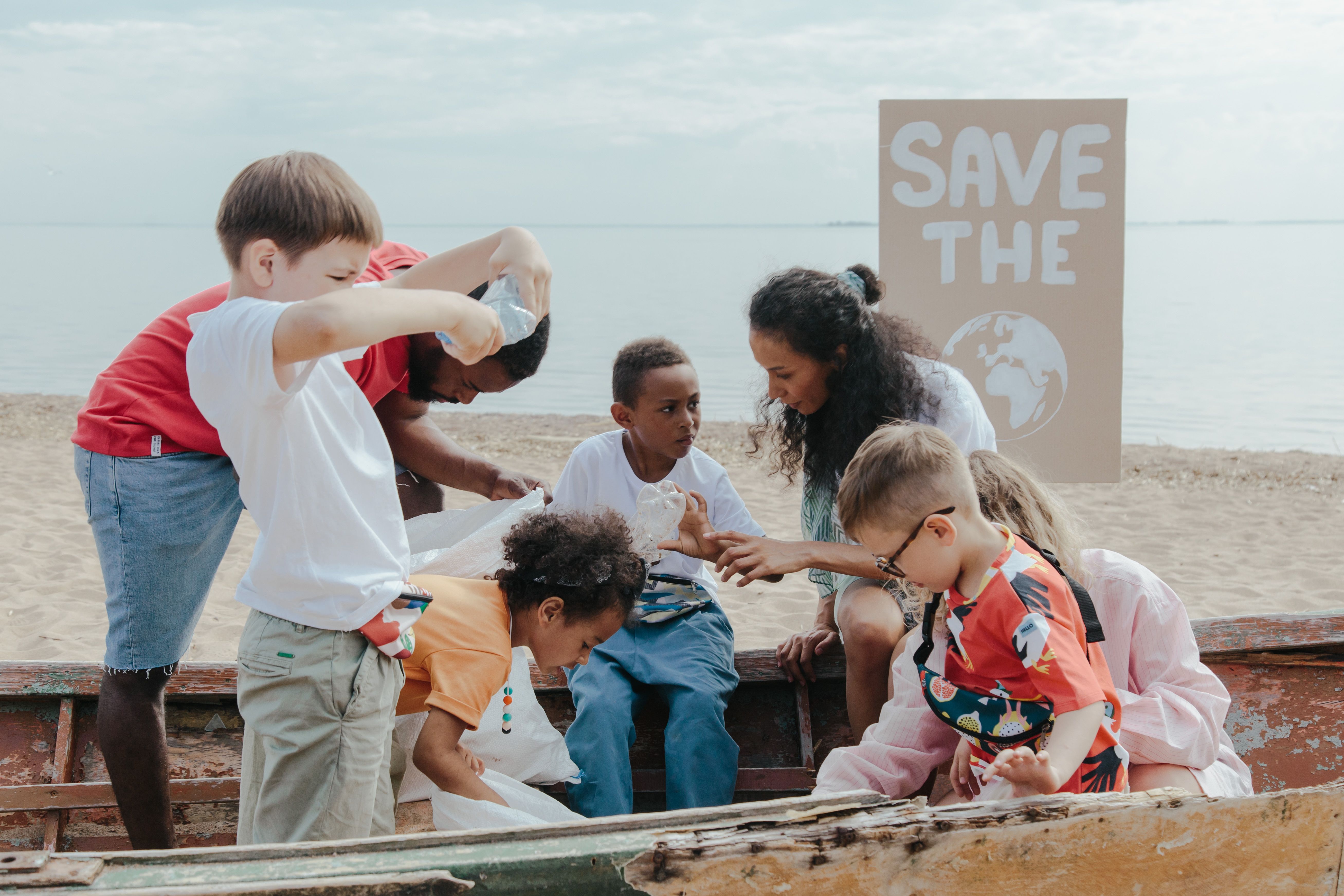 Group of children collecting plastics on a beach cleanup