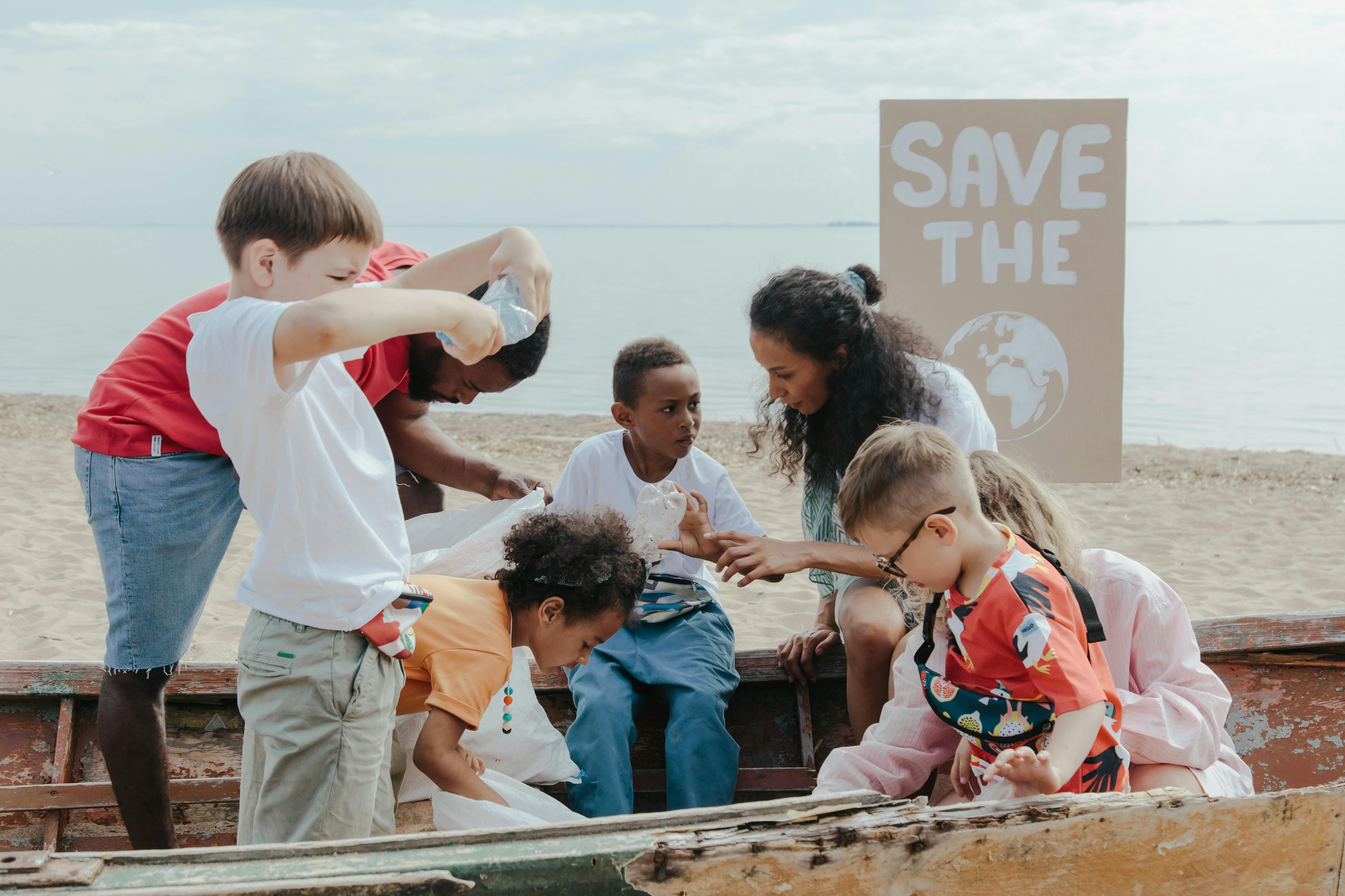 Group of children collecting plastics on a beach cleanup